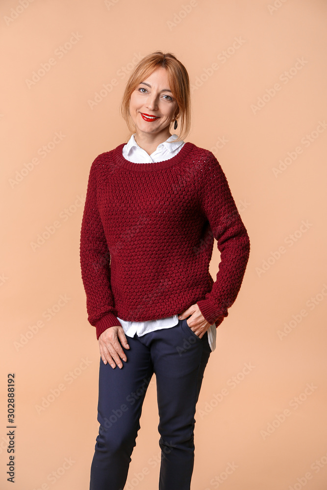 Stylish mature woman on color background