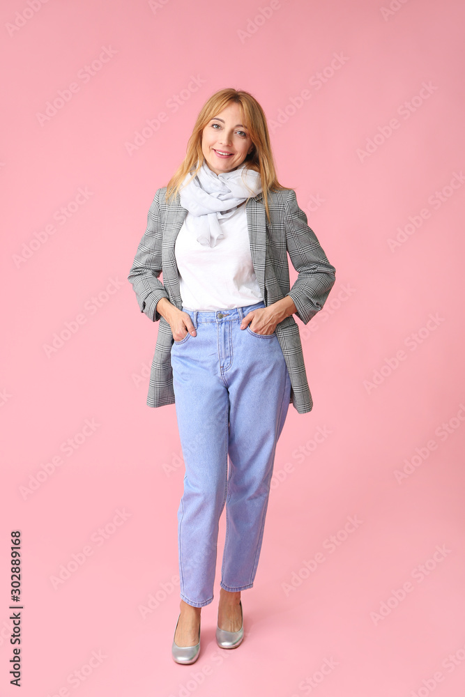 Stylish mature woman on color background