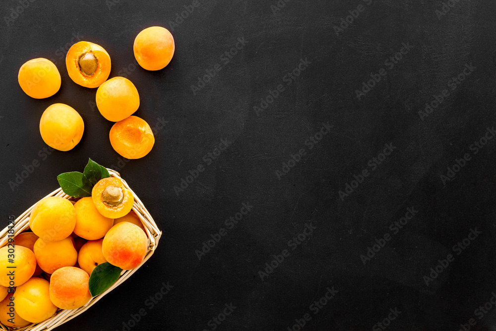 Collect apricots, black background top view space for text, pattern with leaves