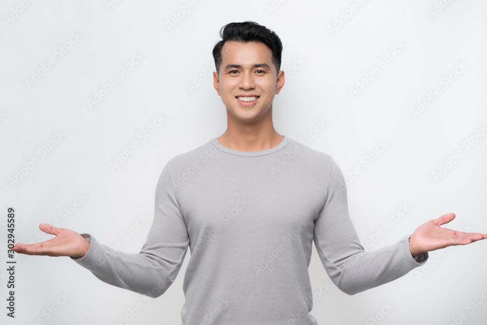 Happy young asian man celebrates with two hand in the air on isolate white background.