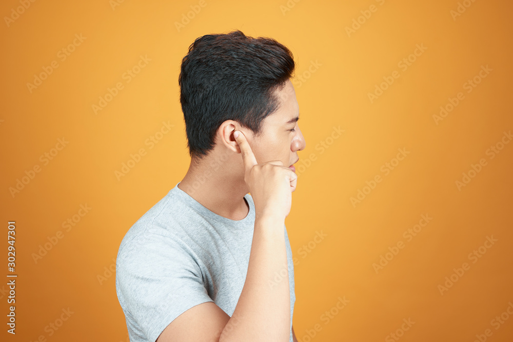 the Asian man raised his ears to the hearing with his hand