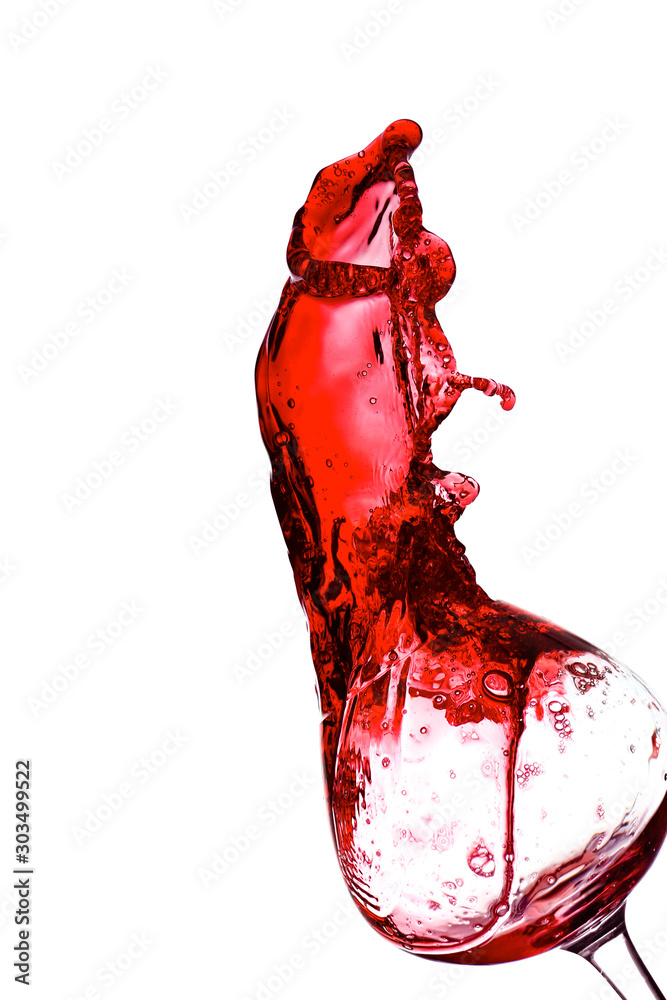 Glass with splashing red wine on white background