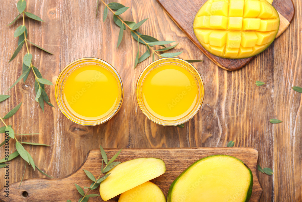 Composition with tasty mango and juice on table