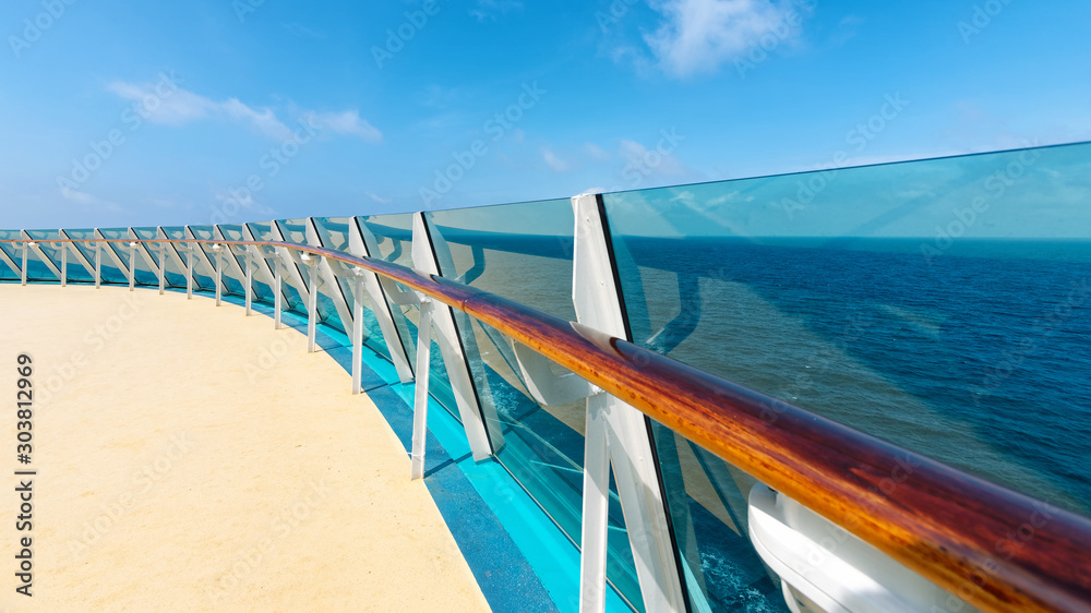 Cruise Ship Deck and railing with Ocean View in sunny day, blue sea and blue sky background.