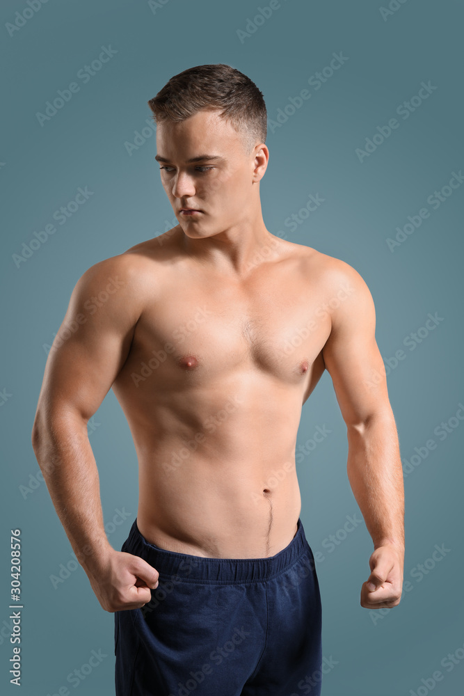 Handsome male bodybuilder on grey background