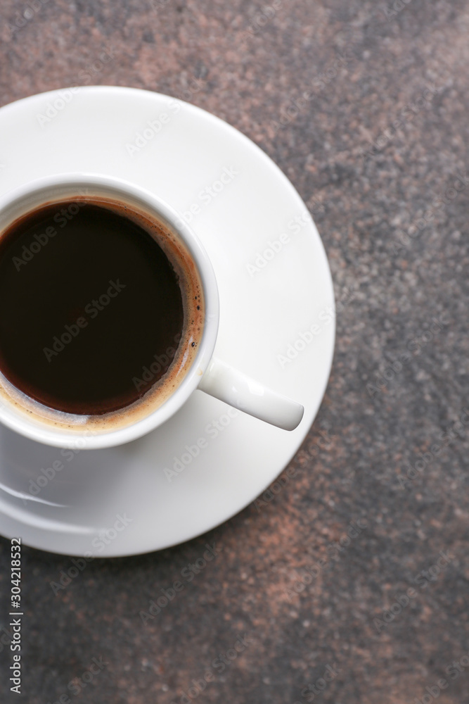 Cup of hot coffee on grey background