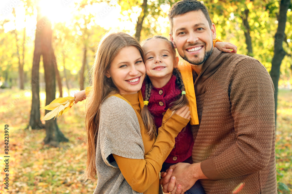 Happy family in autumn park