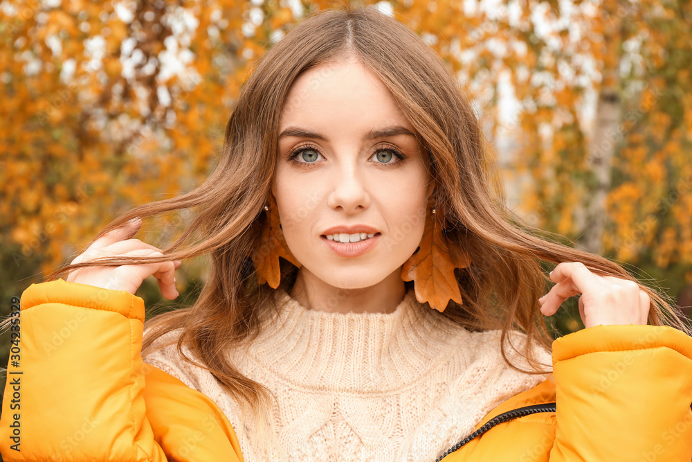 Portrait of stylish young woman in autumn park