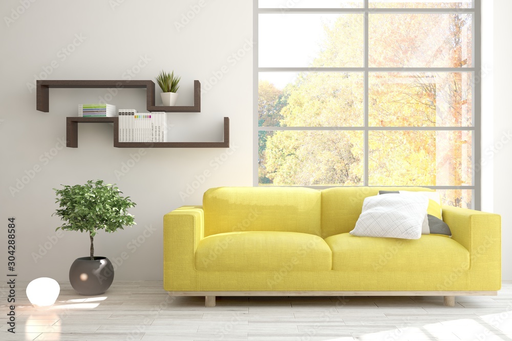 Stylish room in white color with sofa and autumn landscape in window. Scandinavian interior design. 