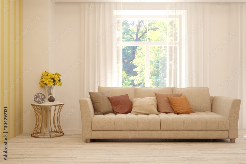 Stylish room in white color with sofa and summer landscape in window. Scandinavian interior design. 