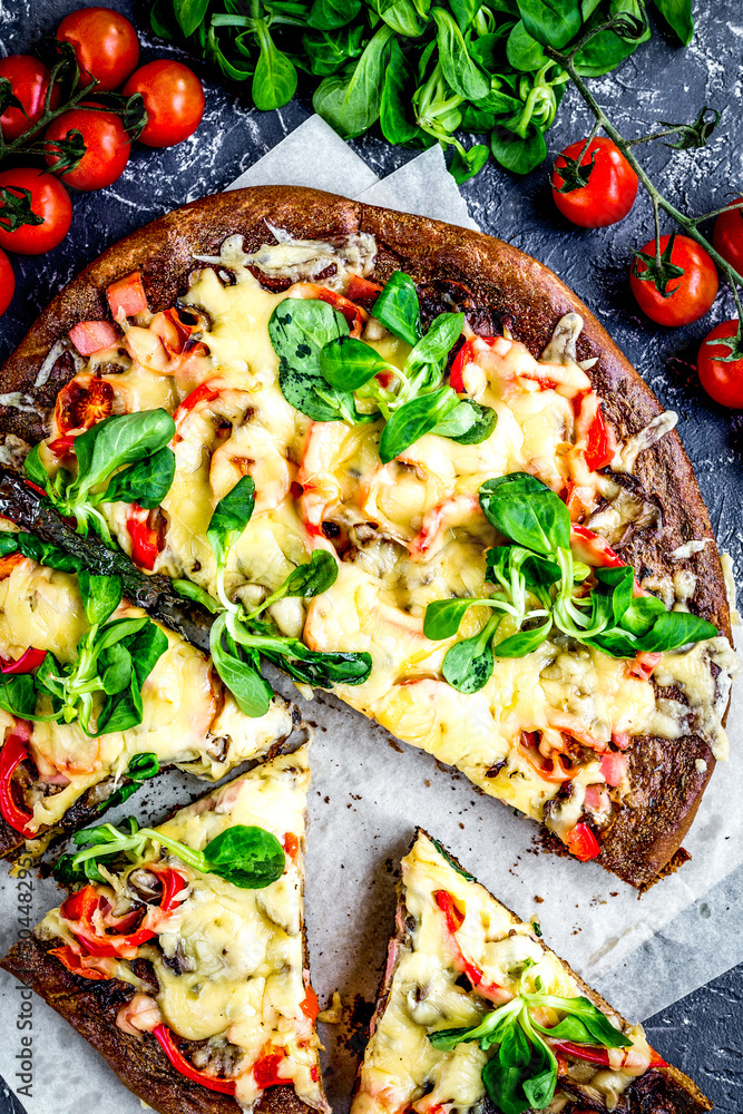 restaurant kitchen with pizza preparing on stone background top view