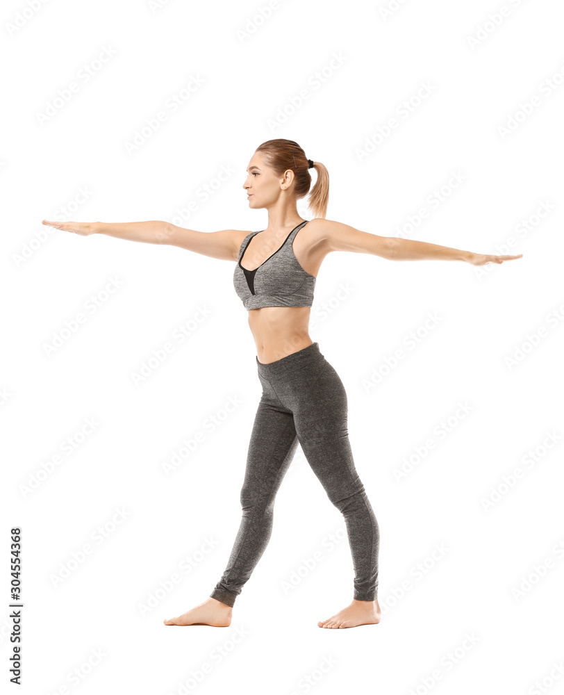 Beautiful young woman practicing yoga on white background