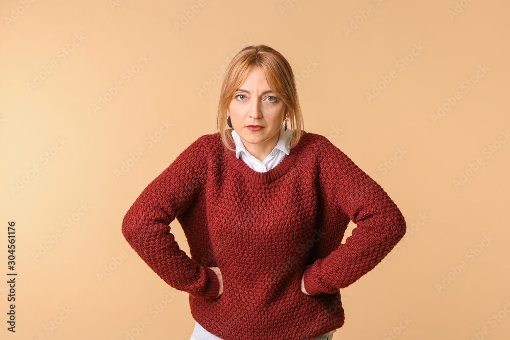 Angry mature woman on color background