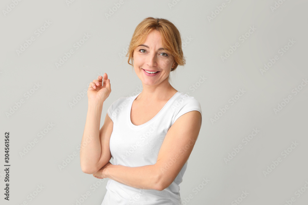 Beautiful mature woman on light background