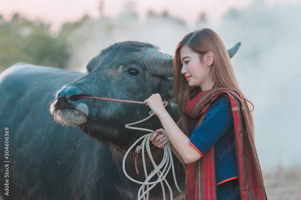 The women of the village with buffalo at countryside.