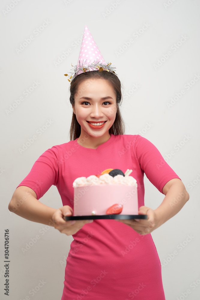 Asian birthday girl looking at camera with smile.