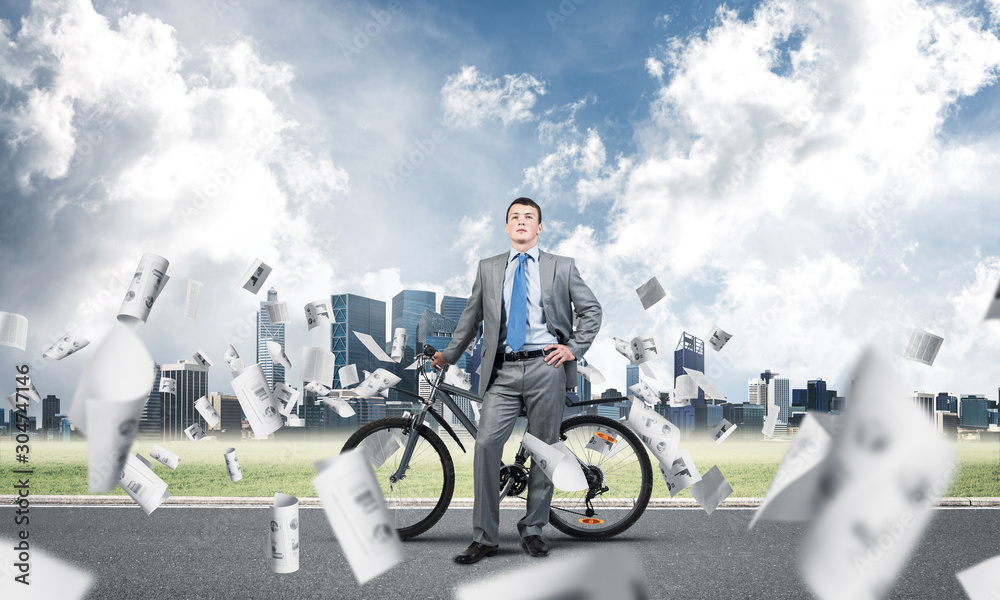 Man wearing business suit on road with bike