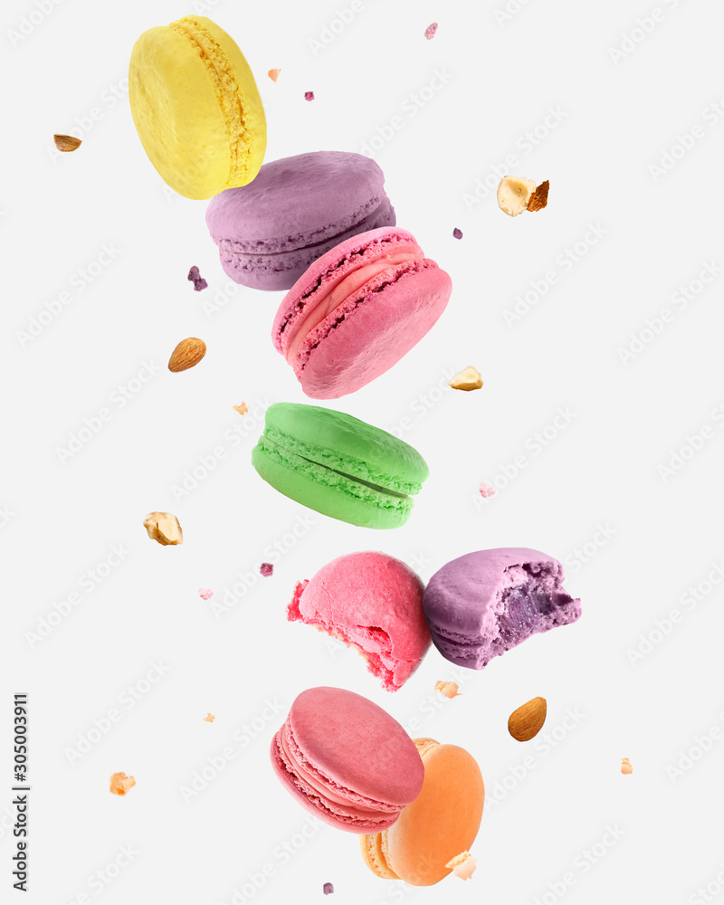 Falling tasty macarons on white background