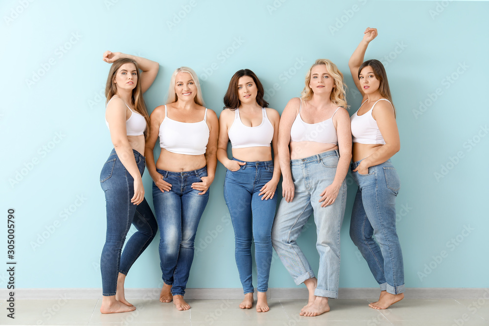 Group of body positive women near color wall