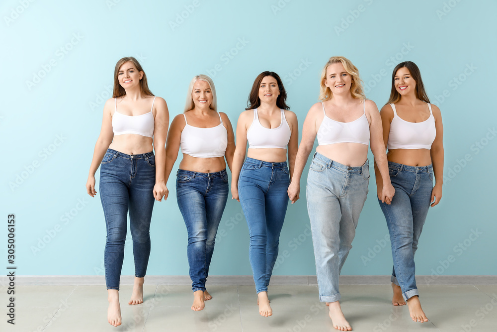 Group of body positive women near color wall