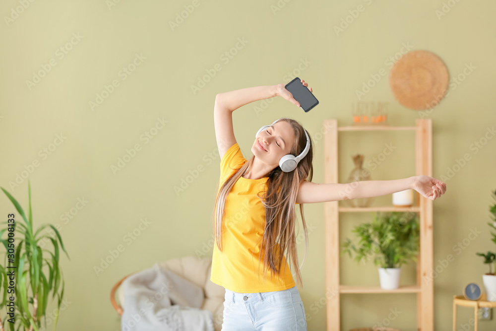 Dancing woman listening to music at home