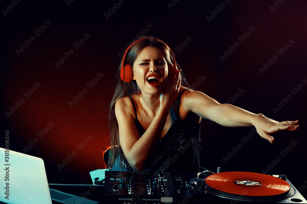 Female dj playing music in nightclub