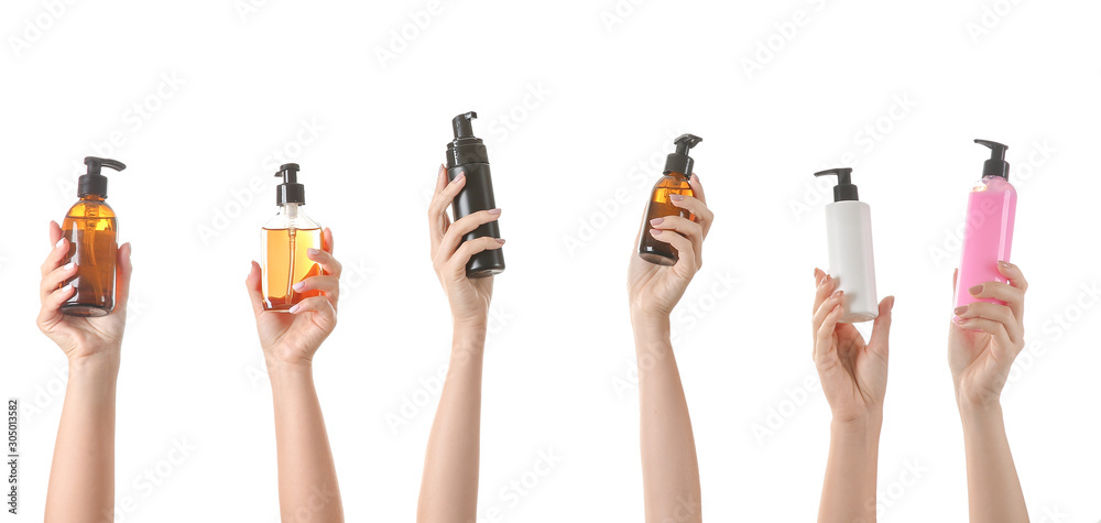 Female hands with different cosmetic products in bottles on white background