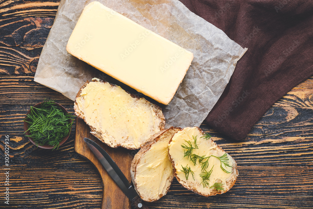 Tasty fresh bread with butter on table