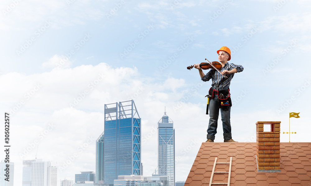 Beautiful woman in safety helmet playing violin