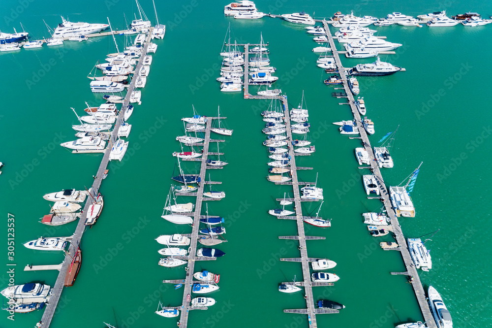 Aerial View Top down Drone shot of Yacht and sailboat parking  in marina Transportation and travel b