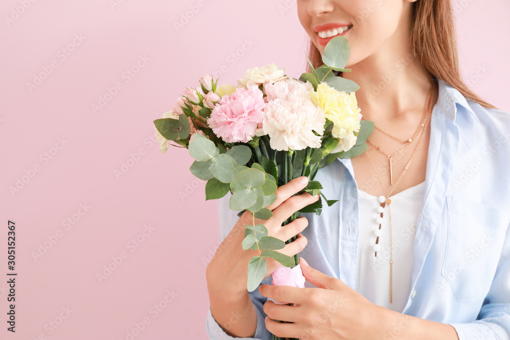 Beautiful young woman with bouquet of carnation flowers on color background