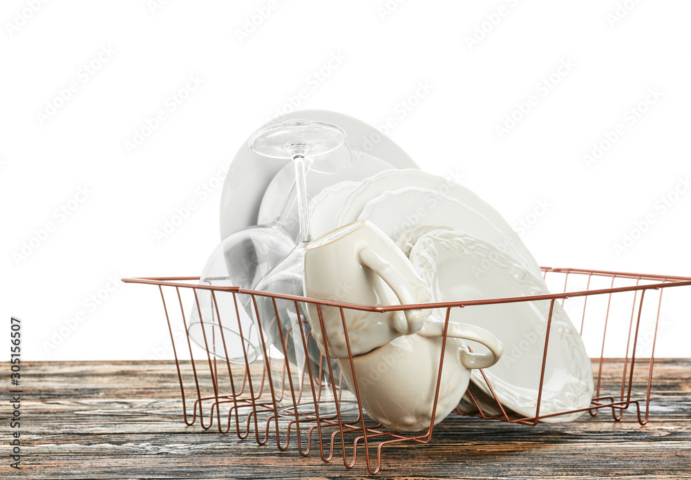 Set of clean dishes on table against white background