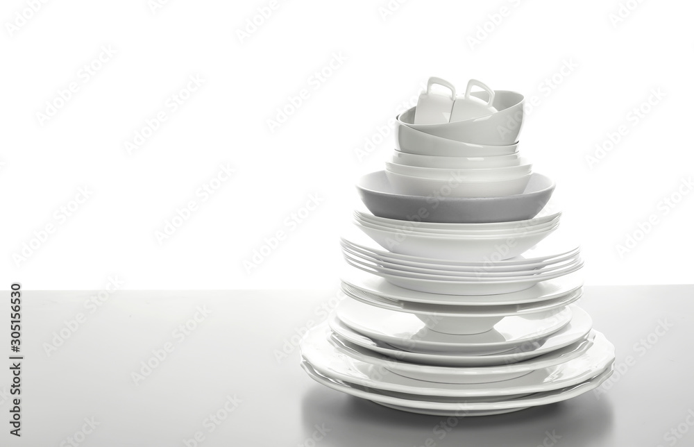 Set of clean tableware on white background