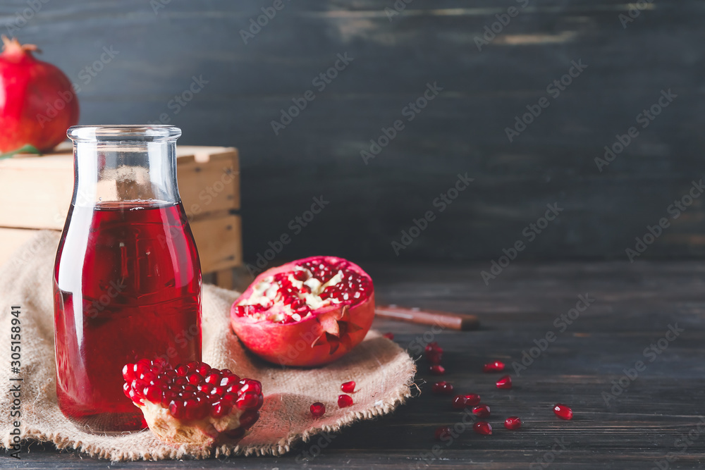 Bottle of tasty pomegranate juice on table