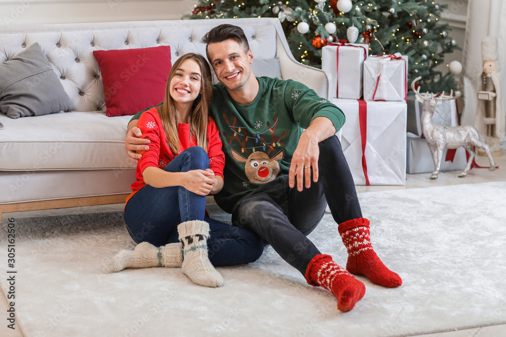 Happy young couple on Christmas eve at home