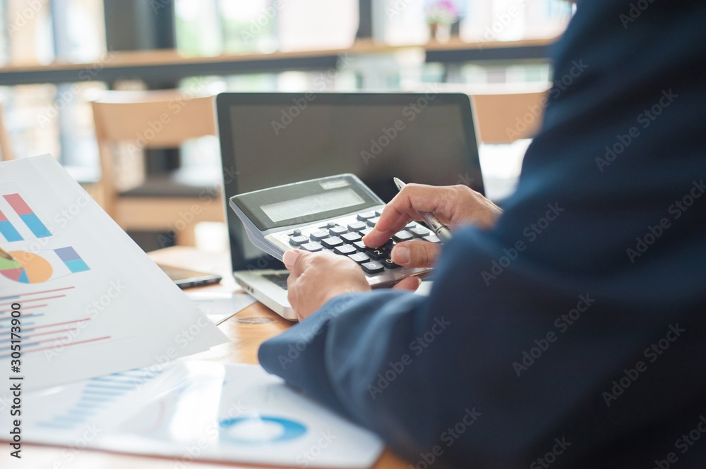 Business people carrying calculators calculating business profits and investments.