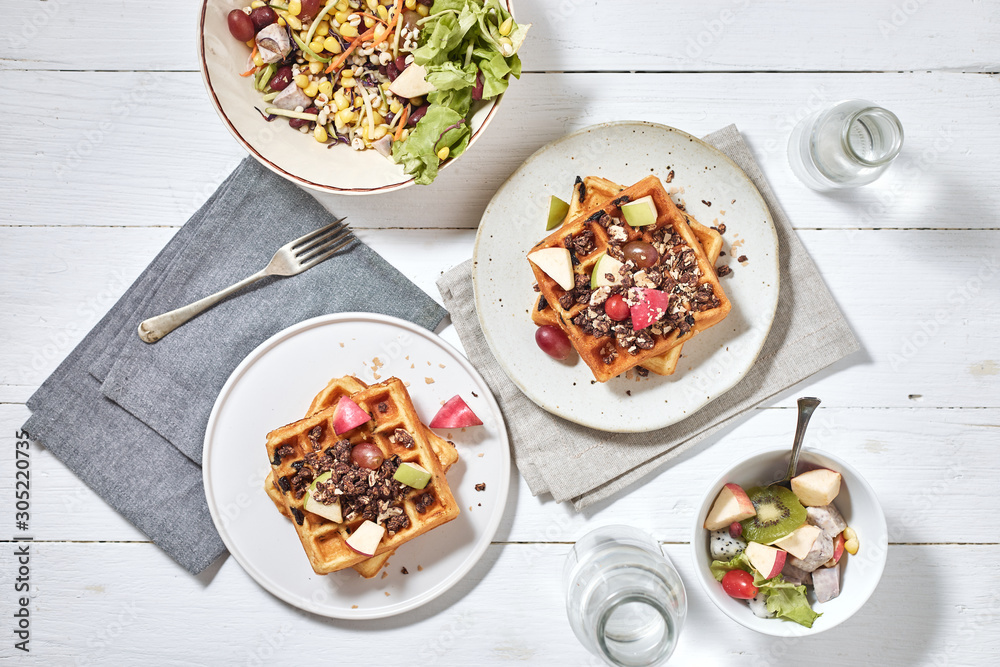 Homemade waffles with fruit and granola..