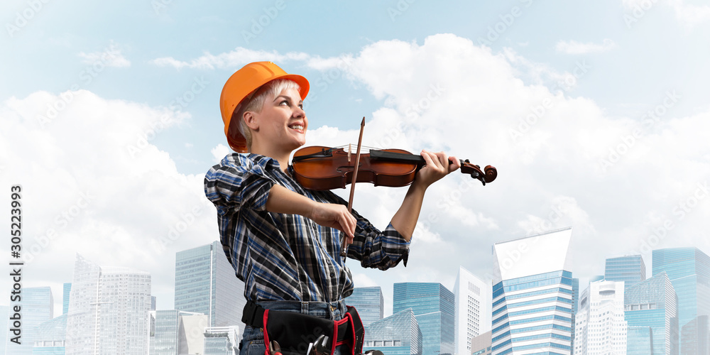 Beautiful woman in safety helmet playing violin