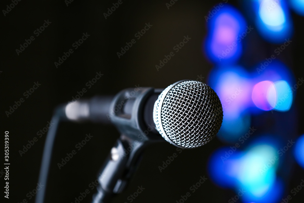 Microphone on dark background with defocused lights