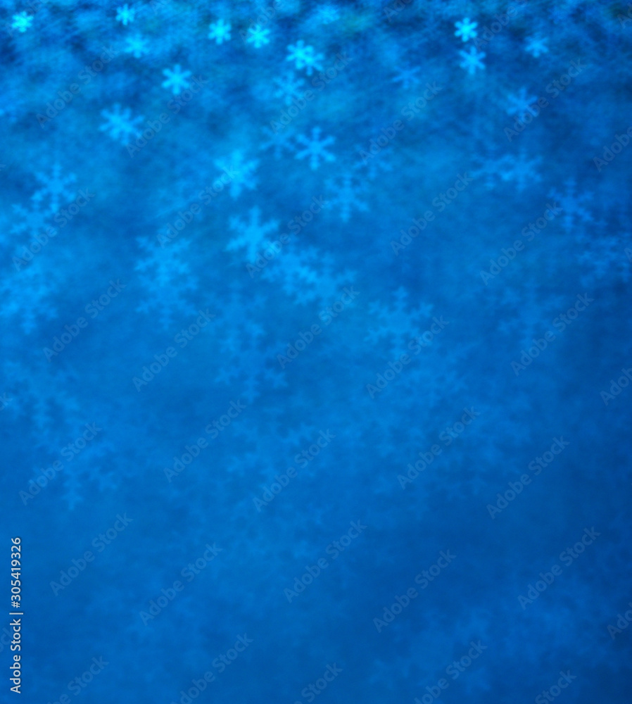 Blue snowflakes bokeh abstract background.