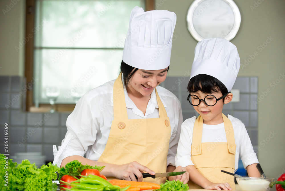 mother with son preparing fresh salad