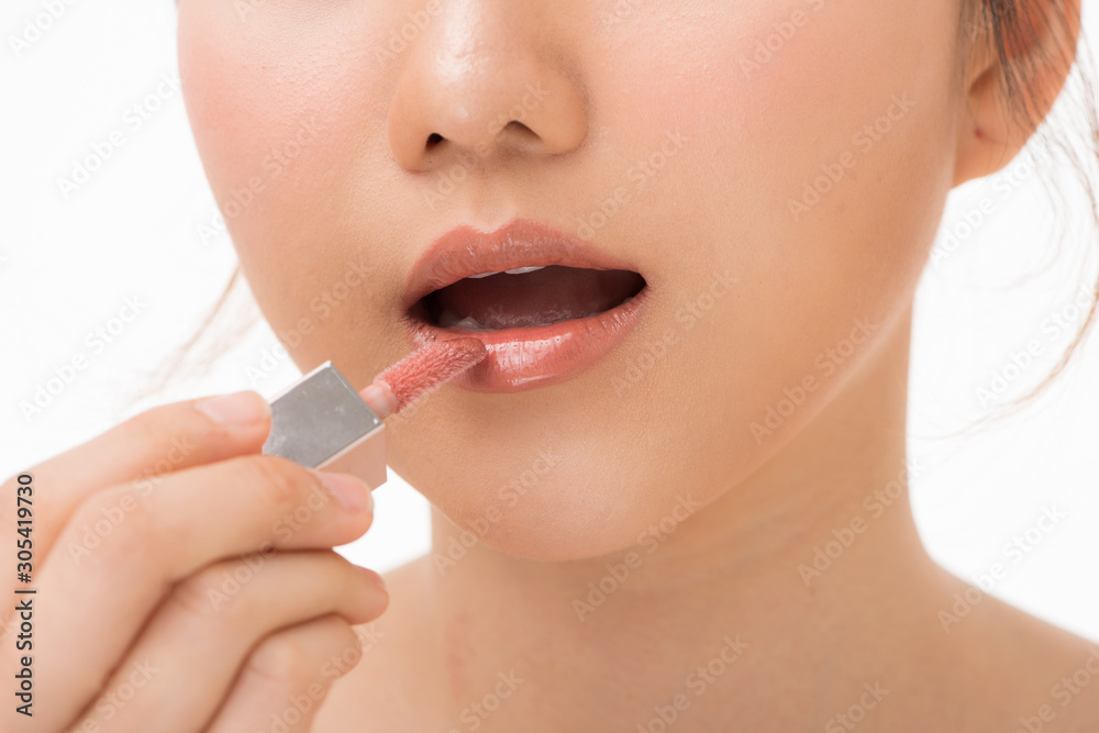 Young beautiful woman professional beauty vlogger or blogger applying lipstick cream to her mouth, d