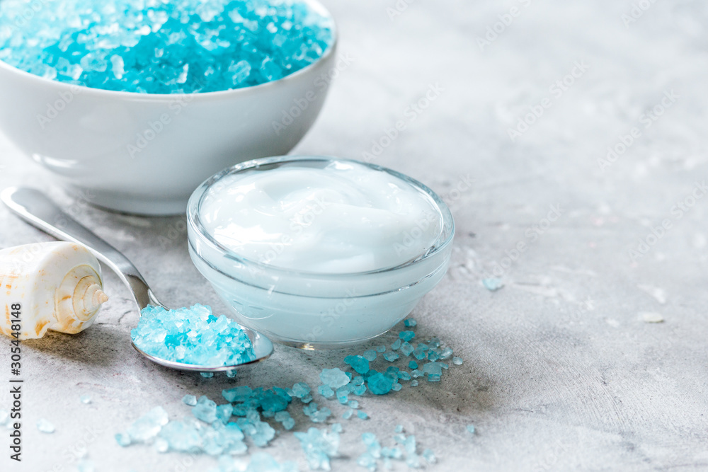 blue spa composition with shells and natural soap on stone desk background