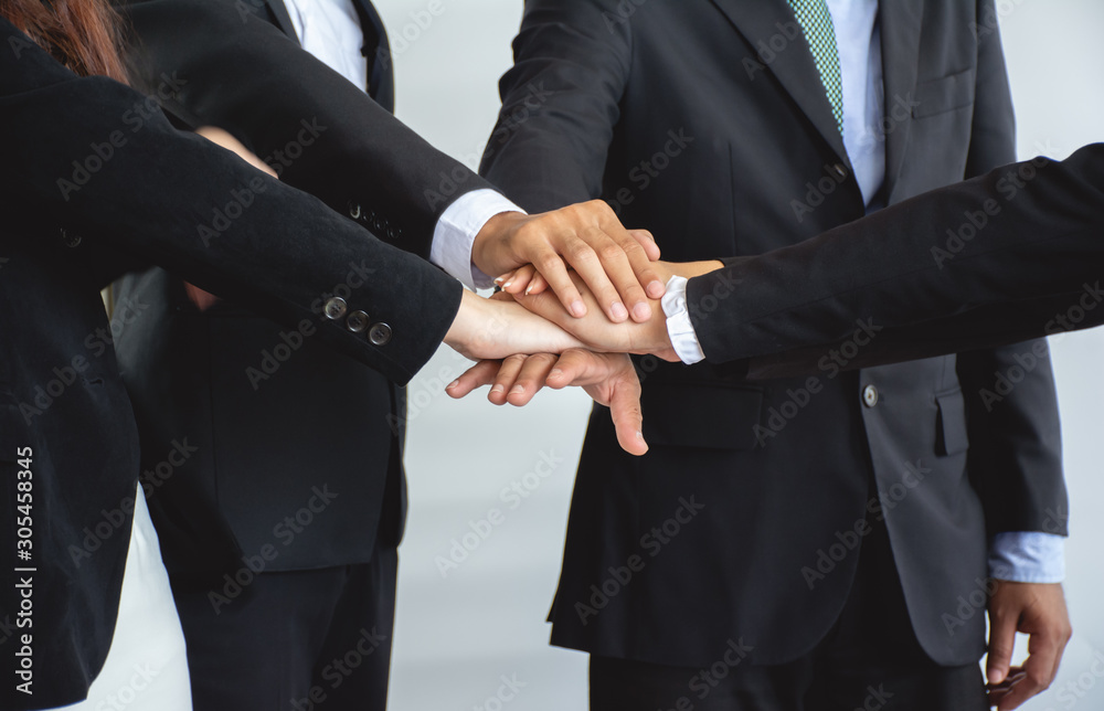 Teamwork of business people holding hands together on meeting.