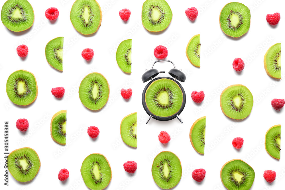 Many sweet ripe kiwi and raspberry on white background