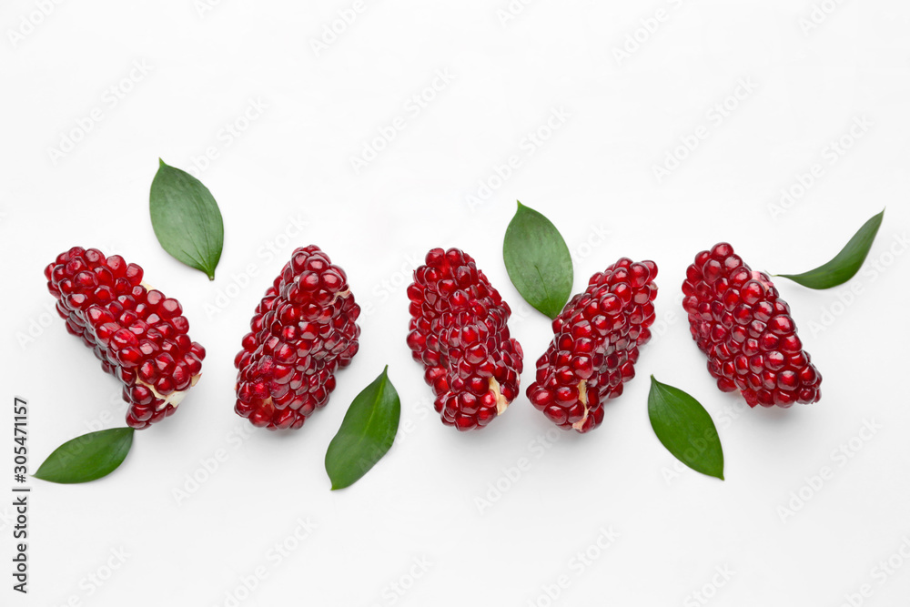 Pieces of ripe tasty pomegranate on white background