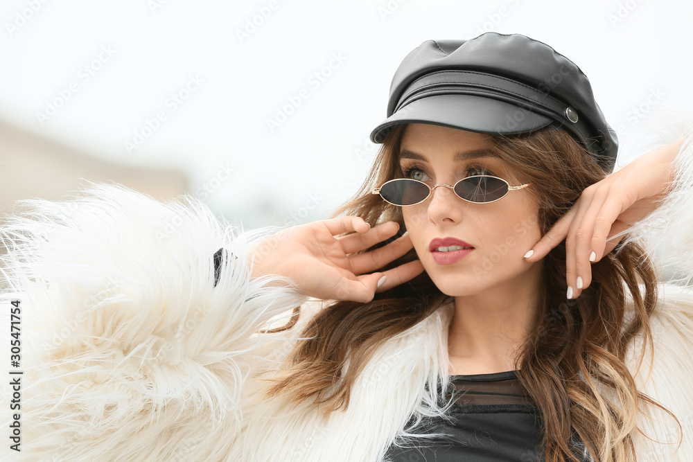 Portrait of stylish young woman on autumn day