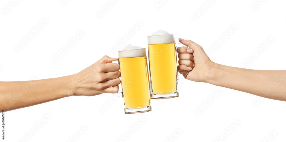 Hands clinking mugs of beer on white background