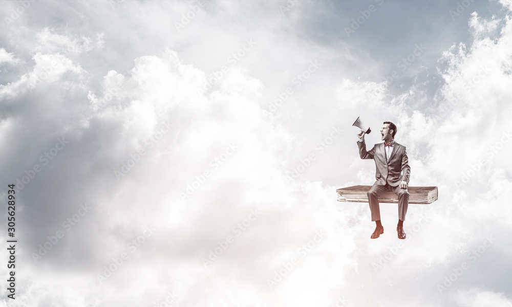 Businessman floating in blue sky and announcing something in loudspeaker