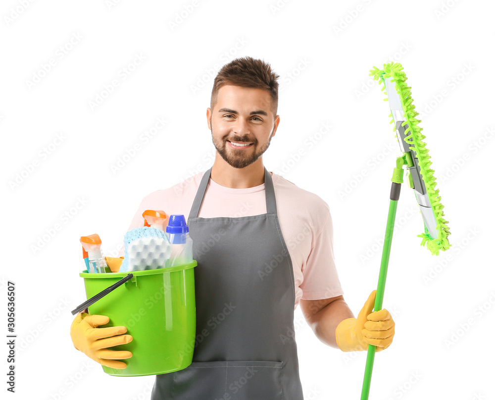 Male janitor with cleaning supplies on white background